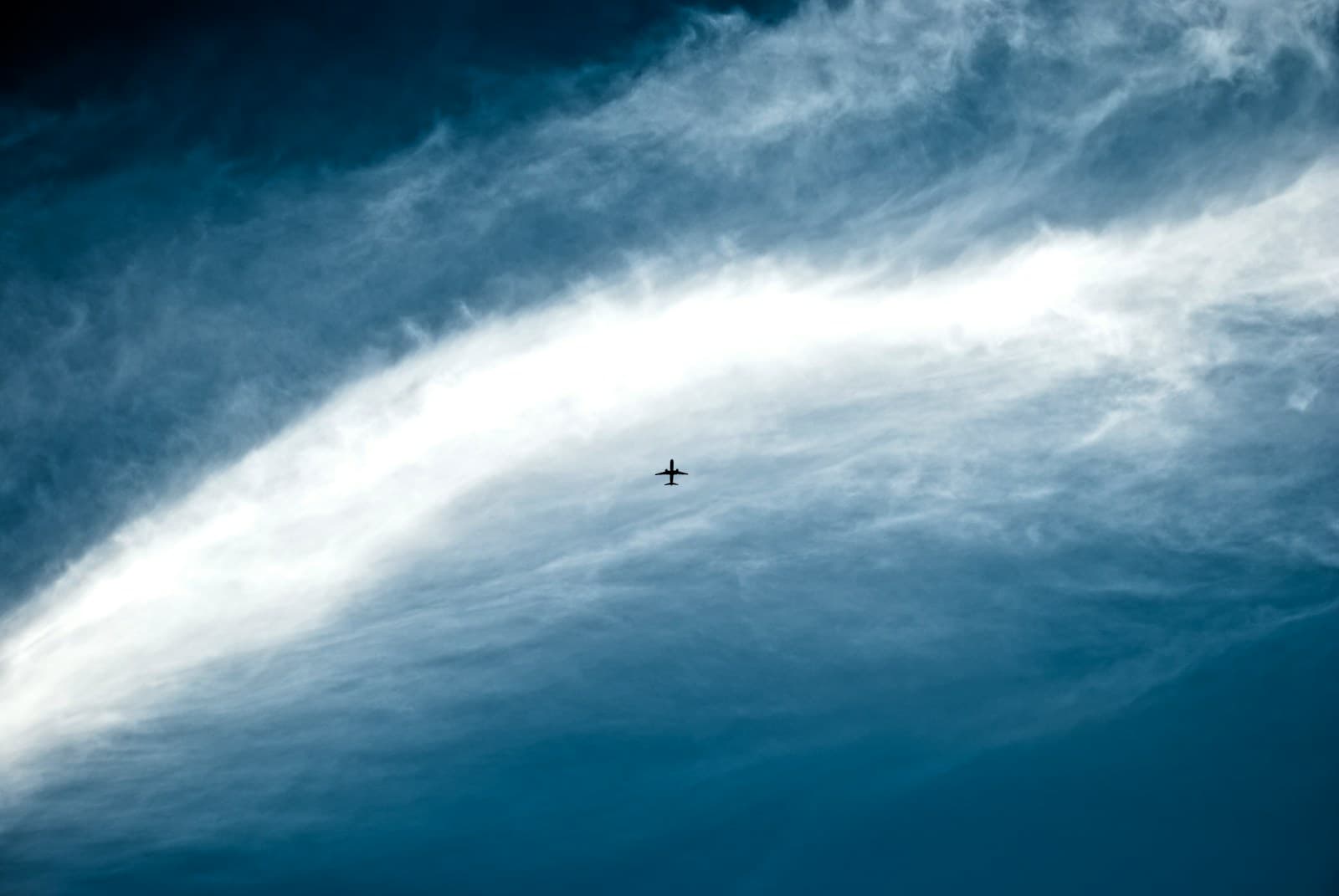 Jet aircraft high against a blue sky